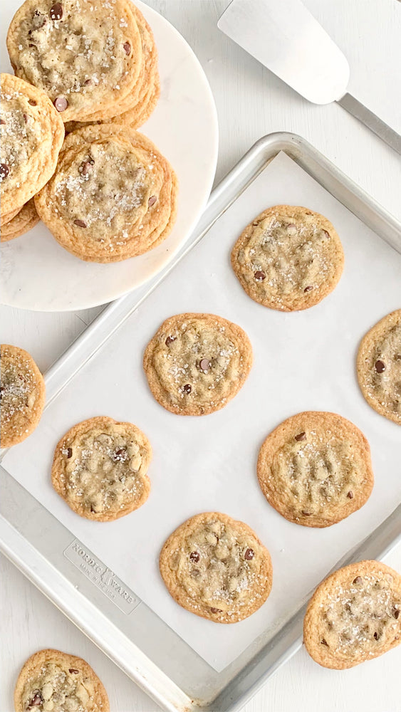Chocolate Chip Cookies on a baking sheet and cookie plate